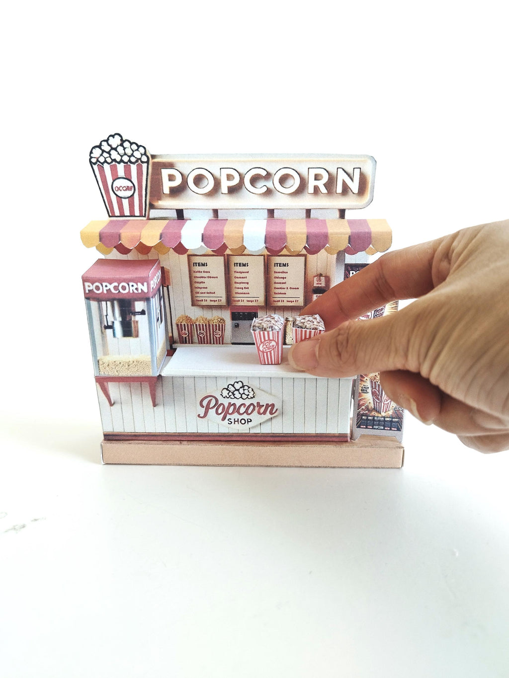 Whether as a wall decoration or a heartfelt gift, this customizable template lets you create a personalized tribute to the beauty of  Popcorn shop. This printable template brings creative 3D design to life in the form of a charming Popcorn shop miniature pop-up frame. Download and personalize it for those who appreciate the delicate. orange red color
