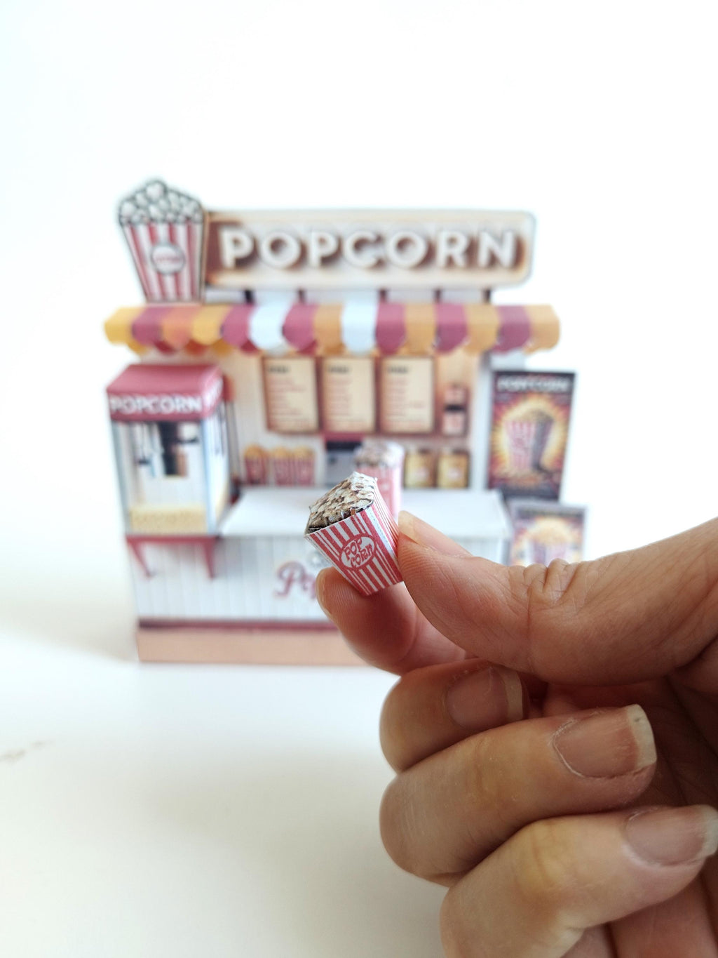 Whether as a wall decoration or a heartfelt gift, this customizable template lets you create a personalized tribute to the beauty of  Popcorn shop. This printable template brings creative 3D design to life in the form of a charming Popcorn shop miniature pop-up frame. Download and personalize it for those who appreciate the delicate. orange red color