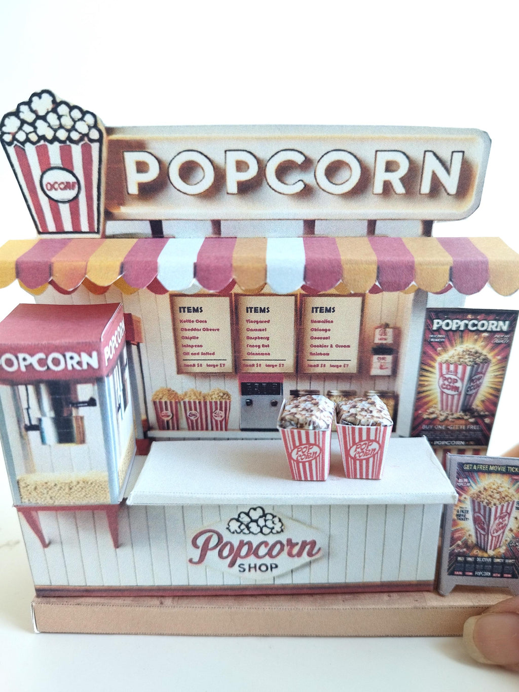 Whether as a wall decoration or a heartfelt gift, this customizable template lets you create a personalized tribute to the beauty of  Popcorn shop. This printable template brings creative 3D design to life in the form of a charming Popcorn shop miniature pop-up frame. Download and personalize it for those who appreciate the delicate. orange red color