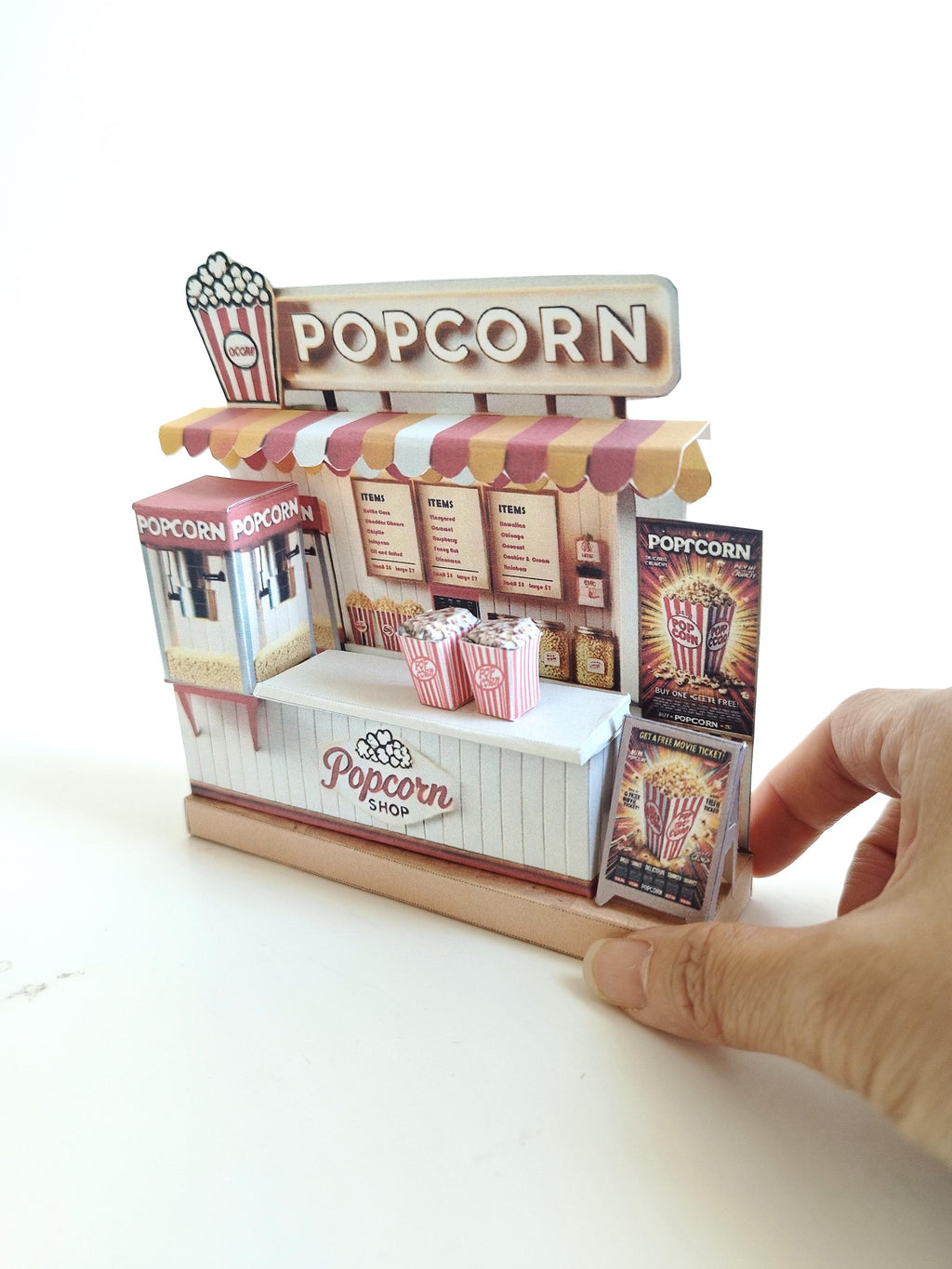 Whether as a wall decoration or a heartfelt gift, this customizable template lets you create a personalized tribute to the beauty of  Popcorn shop. This printable template brings creative 3D design to life in the form of a charming Popcorn shop miniature pop-up frame. Download and personalize it for those who appreciate the delicate. orange red color