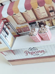 Whether as a wall decoration or a heartfelt gift, this customizable template lets you create a personalized tribute to the beauty of  Popcorn shop. This printable template brings creative 3D design to life in the form of a charming Popcorn shop miniature pop-up frame. Download and personalize it for those who appreciate the delicate. orange red color