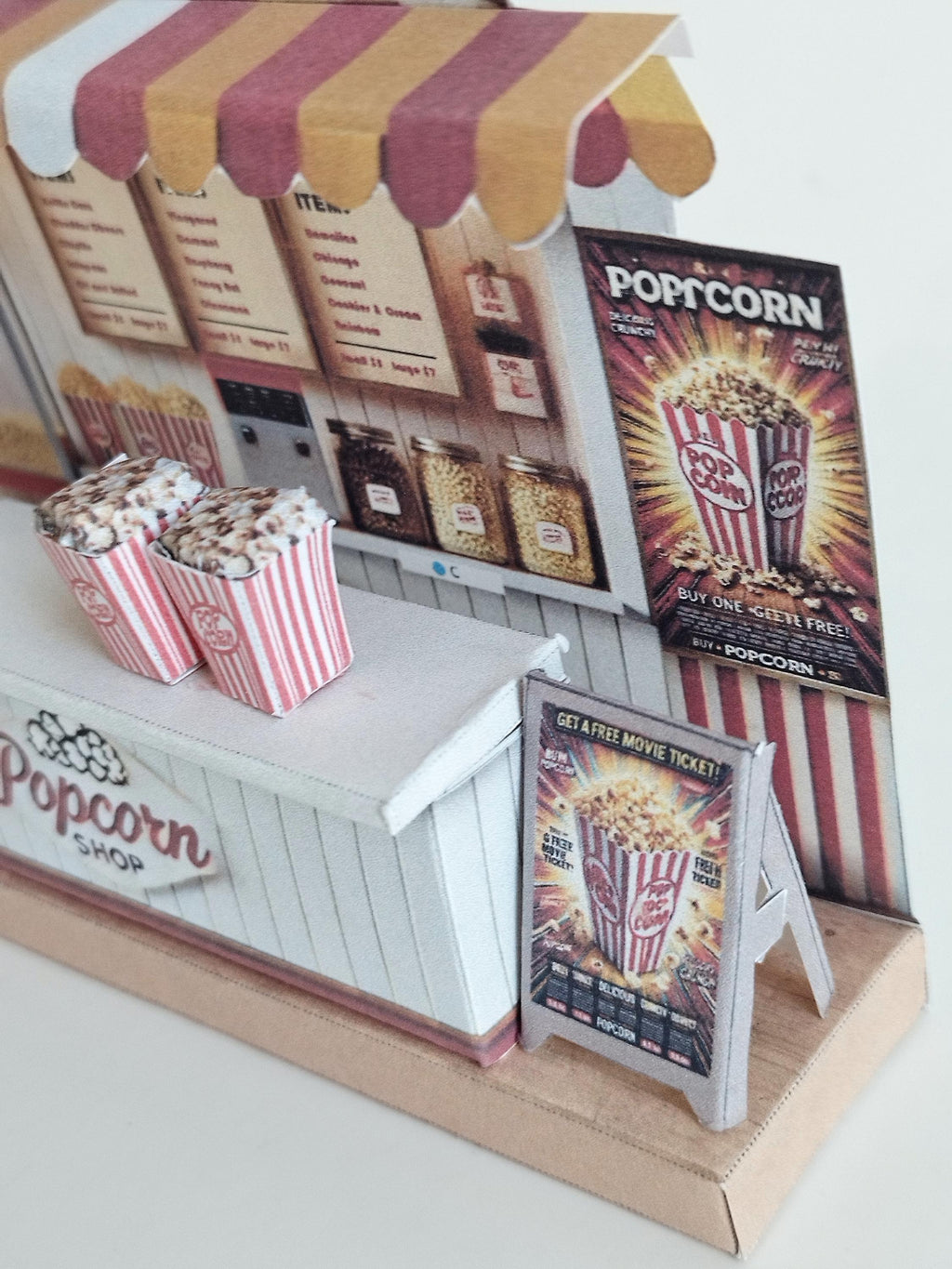 Whether as a wall decoration or a heartfelt gift, this customizable template lets you create a personalized tribute to the beauty of  Popcorn shop. This printable template brings creative 3D design to life in the form of a charming Popcorn shop miniature pop-up frame. Download and personalize it for those who appreciate the delicate. orange red color