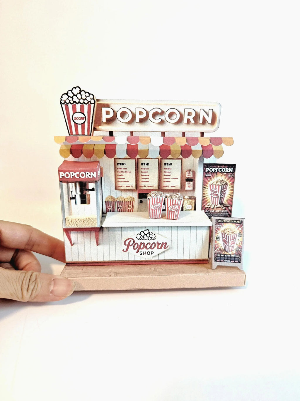 Whether as a wall decoration or a heartfelt gift, this customizable template lets you create a personalized tribute to the beauty of  Popcorn shop. This printable template brings creative 3D design to life in the form of a charming Popcorn shop miniature pop-up frame. Download and personalize it for those who appreciate the delicate. orange red color