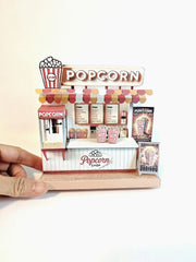 Whether as a wall decoration or a heartfelt gift, this customizable template lets you create a personalized tribute to the beauty of  Popcorn shop. This printable template brings creative 3D design to life in the form of a charming Popcorn shop miniature pop-up frame. Download and personalize it for those who appreciate the delicate. orange red color