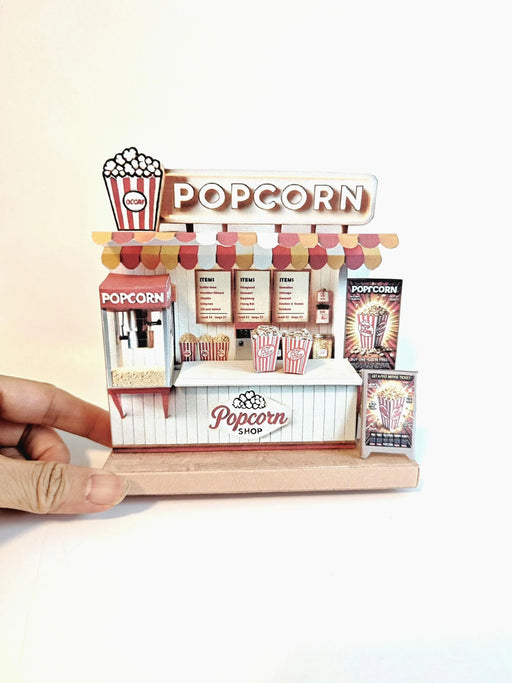 Whether as a wall decoration or a heartfelt gift, this customizable template lets you create a personalized tribute to the beauty of  Popcorn shop. This printable template brings creative 3D design to life in the form of a charming Popcorn shop miniature pop-up frame. Download and personalize it for those who appreciate the delicate. orange red color